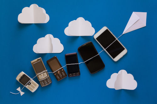 Technology evolution concept. Vintage and new phomes flying on p Change in technology